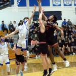 RYAN SPARKS | THE DAILY WORLD Elmas Gibson Cain (25) and Teninos Takari Hickle (0) leap for a rebound during Elmas 50-47 loss on Tuesday in Elma.