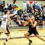 PHOTO BY LARRY BALE Raymond guard Tre Seydel (12) looks to shoot while being defended by South Bends Jacob Carlson (30) during Raymonds 74-34 victory on Wednesday at South Bend High School. With 26 points scored in the game, Seydel passed Ken Hoffer for the top spot as the schools all-time scoring leader for boys basketball.