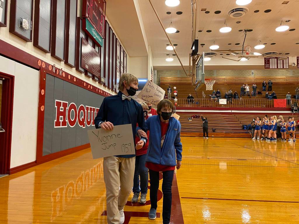 Yvone Jump '59 leads the Title IX honoree progression before taking a spot at center court to greet athletes. Erika Gebhardt I The Daily World