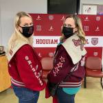 Tifanie Kelly '97 (left) and Mandie Svoboda '97 (right), show off their old varsity jackets at Friday night's dinner. Erika Gebhadt I The Daily World