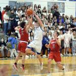 RYAN SPARKS | THE DAILY WORLD Elmas Traden Carter (13) drives to the basket against Castle Rocks Trevor Rogen (2) and Lane Partridge during the Eagles 57-47 loss in the 1A District 4 Tournament on Thursday in Elma.