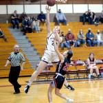 RYAN SPARKS | THE DAILY WORLD Montesano senior Paige Lisherness (23) glides to the basket against Columbia-White Salmons Chloe Clifford to score two of her game high 32 points in the Bulldogs 79-29 victory on Friday in Montesano.
