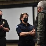Matthew N. Wells | The Daily World 
Aberdeen Fire Service Specialist Monica Myers, center, receives an award and shakes hands with Mike Michener, community volunteer lead from American Red Cross South Puget Sound and Olympics Chapter, as Aberdeen Fire Chief Tom Hubbard applauds the moment on Friday, Feb. 11, 2022.