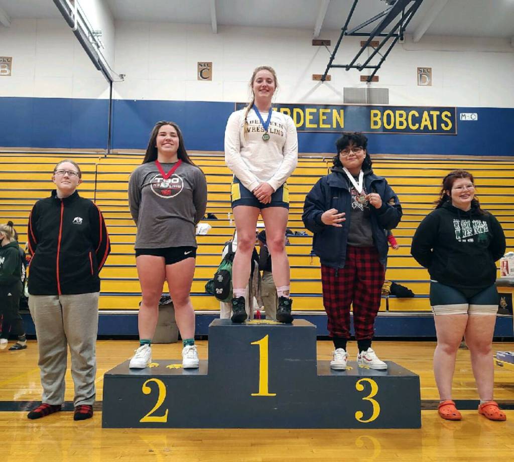 SUBMITTED PHOTO Aberdeen Katie Gakes Gakin, center, stands atop the podium after winning the 190-pound weight class at the 2A Region 3 Tournament on Saturday in Aberdeen.