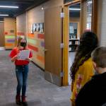 Lincoln Elementary School student Harley Quimbey leads a group of fellow students and community members through the building, making stops in the office, East Wing, West Wing, and gym. Erika Gebhardt I The Daily World