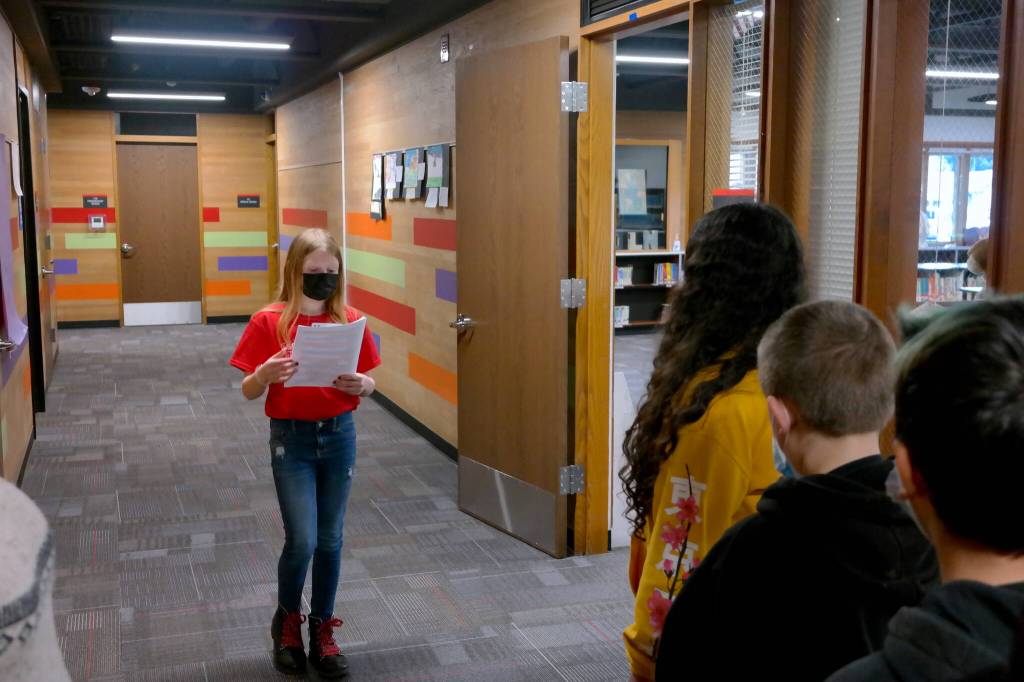 Lincoln Elementary School student Harley Quimbey leads a group of fellow students and community members through the building, making stops in the office, East Wing, West Wing, and gym. Erika Gebhardt I The Daily World