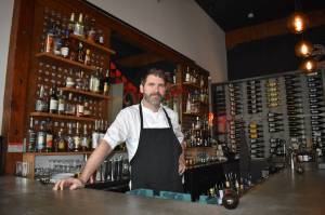Redivivas owner and Chef Andy Bickar proudly stands behind his bar, his staff and his food. The 2000 Aberdeen High School graduate crafts locally-sourced food in such a way that guests leave full and happy. (Matthew N. Wells | The Daily World)