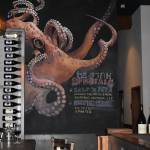 Local artists, such as Jenny Fishers octopus, paint the interior decor at Rediviva. Edison Lightbulbs light up the bar and provide an intimate feeling for the Pacific Northwest restaurant. (Matthew N. Wells | The Daily World)