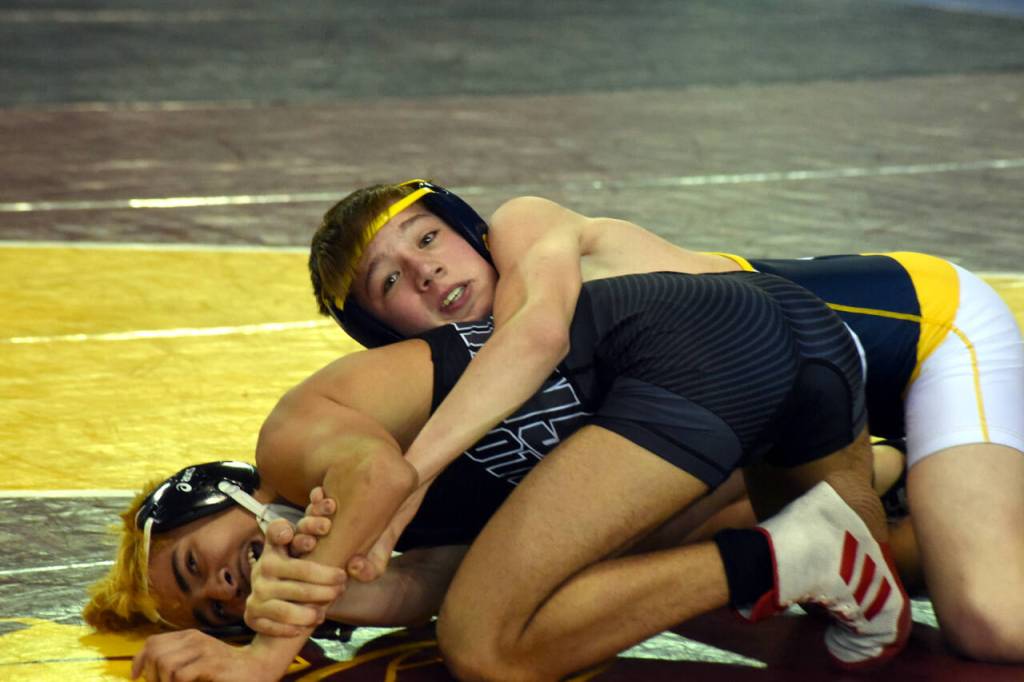 PHOTO BY SUE MICHALAK BUDSBERG Aberdeens Mikey Hatton, top, wrestles at the Mat Classic XXXII state-championship tournament on Friday at the Tacoma Dome.