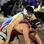 PHOTO BY SUE MICHALAK BUDSBERG Elmas Donovan Bishop, top, wrestles at the Mat Classic XXXII state-championship tournament on Friday at the Tacoma Dome.