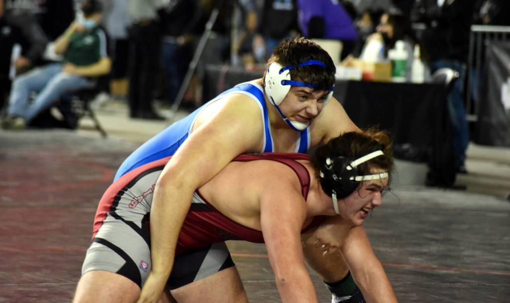PHOTO BY SUE MICHALAK BUDSBERG Elmas Donovan Bishop, top, wrestles at the Mat Classic XXXII state-championship tournament on Friday at the Tacoma Dome.