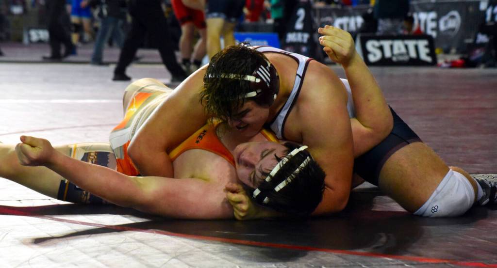 PHOTO BY SUE MICHALAK BUDSBERG Montesanos Alex Delgado, top, wrestles at the Mat Classic XXXII state-championship tournament on Friday at the Tacoma Dome.
