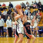 RYAN SPARKS | THE DAILY WORLD Montesanos Mikayla Stanfield, left, drives to the basket against Teninos Megan Letts (11) during the Bulldogs 38-35 victory in the 1A District 4 championship game on Saturday at Rochester High School.