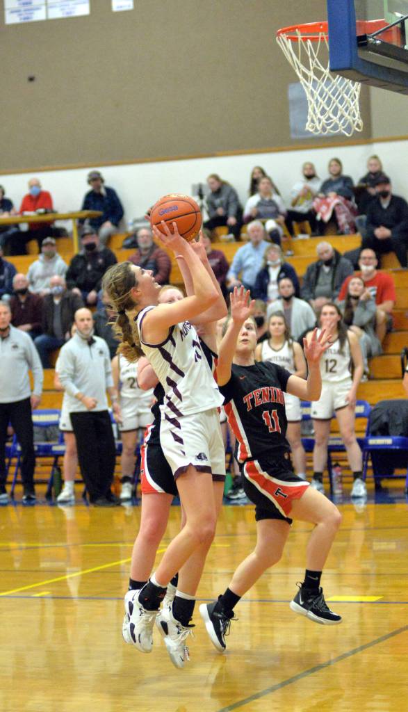 RYAN SPARKS | THE DAILY WORLD Montesanos Mikayla Stanfield, left, drives to the basket against Teninos Megan Letts (11) during the Bulldogs 38-35 victory in the 1A District 4 championship game on Saturday at Rochester High School.