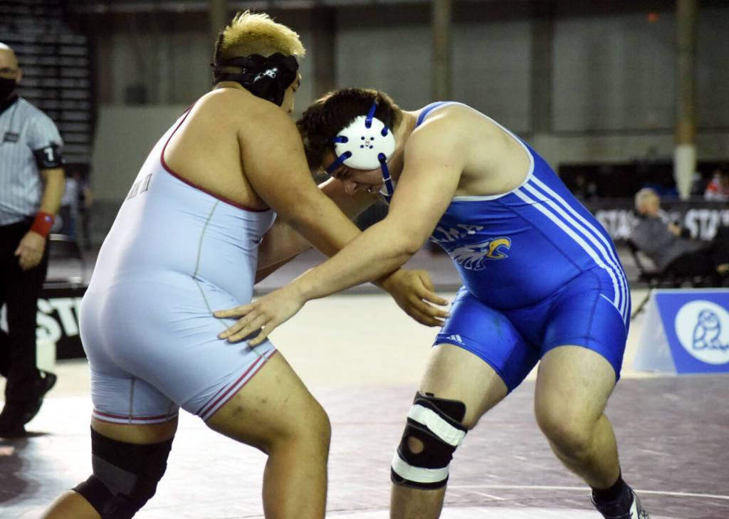 PHOTO BY SUE MICHALAK BUDSBERG Elmas Donovan Bishop, right, tangles with Toppenishs Rocco Clark III in the 1A 220 pound state-championship match on Saturday at the Mat Classic XXXIII meet in Tacoma.