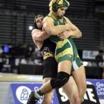 PHOTO BY SUE MICHALAK BUDSBERG North Beachs Westin Fruh, left, hoists Liberty Bells Noah Holston in the 1B/2B 195 pound state-championship match on Saturday at the Mat Classic XXXIII meet in Tacoma.
