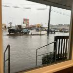 The early afternoon view on Jan. 6, 2022, from inside Alex Kluh American Family Insurance  323 W. Heron Street, in Aberdeen  shows deep flooding that turned South M Street into a small wading pool. (Matthew N. Wells | The Daily World)