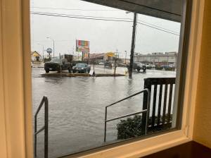 The early afternoon view on Jan. 6, 2022, from inside Alex Kluh American Family Insurance  323 W. Heron Street, in Aberdeen  shows deep flooding that turned South M Street into a small wading pool. (Matthew N. Wells | The Daily World)