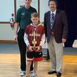 SUBMITTED PHOTO Lawyer Niemi of Montesano won the state championship of the Elks Hoop Shoot Saturday at St. Martins University in Lacey after sinking 21-of-25 shots in the boys 8-9 year-old competition. Niemi is flanked by WA Elks Association President Dave Richcreek, left, and Washington Hoop Shoot Director Joe Basil.