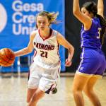 ERIC TRENT | THE CHRONICLE Raymond guard Kyra Gardner (21) dribbles past Mabton power forward Jasmin Chavez during the Seagulls 65-44 victory in the first round of the 2B State Tournament on Wednesday, March 2, 2022 at the Spokane Arena. Gardner led all scorers with 30 points.