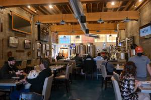 Patrons enjoy a Friday afternoon at Hoquiam Brewing Co. on Feb. 18, 2022. According to co-owner Rob Paylor, the recently expanded kitchen and dining menu has been well-received by the public and features "Northwest Brewery pub-style" cuisine. Erika Gebhardt I The Daily World