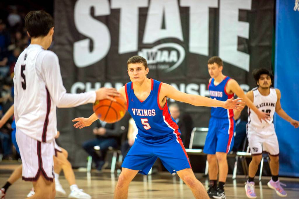 ERIC TRENT | THE CHRONICLE Willapa Valleys Wil Clements (5) stares down Lummi Nations Duncan Toby during the Vikings 65-59 loss in a 1B State Boys Basketball Tournament elimination game on Friday at the Spokane Arena.