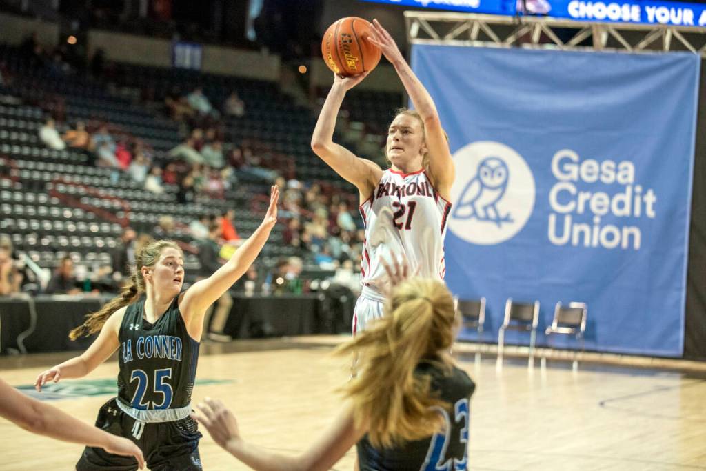 ERIC TRENT | THE CHRONICLE Raymond senior guard Kyra Gardner (21) puts up a jump shot while being defended by La Conners Rachel Cram (25) during a 67-52 loss in the 2B State Tournament fourth/sixth-place game on Saturday at the Spokane Arena. Gardner finished her prep hoops career with a school-record 1,906 points.