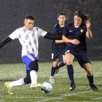 RYAN SPARKS | THE DAILY WORLD Elma midfielder Valencia Mendoza (7) and Aberdeen defender Isaiah Johnson (11) compete for possession during a 1-1 draw on Saturday at Stewart Field in Aberdeen.