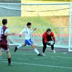 RYAN SPARKS | THE DAILY WORLD Montesano goal keeper Jayden McElravy, right, collects the ball ahead of onrushing Elma attacker Valencia Mendoza during Elmas 3-1 win on Wednesday at Montesano High School.