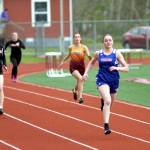 RYAN SPARKS | THE DAILY WORLD Willapa Valleys Emily Wilson, right, leads the field down the stretch of the girls 200 meters at the Henrie-Weisel Tri-District Meet on Thursday in South Bend.