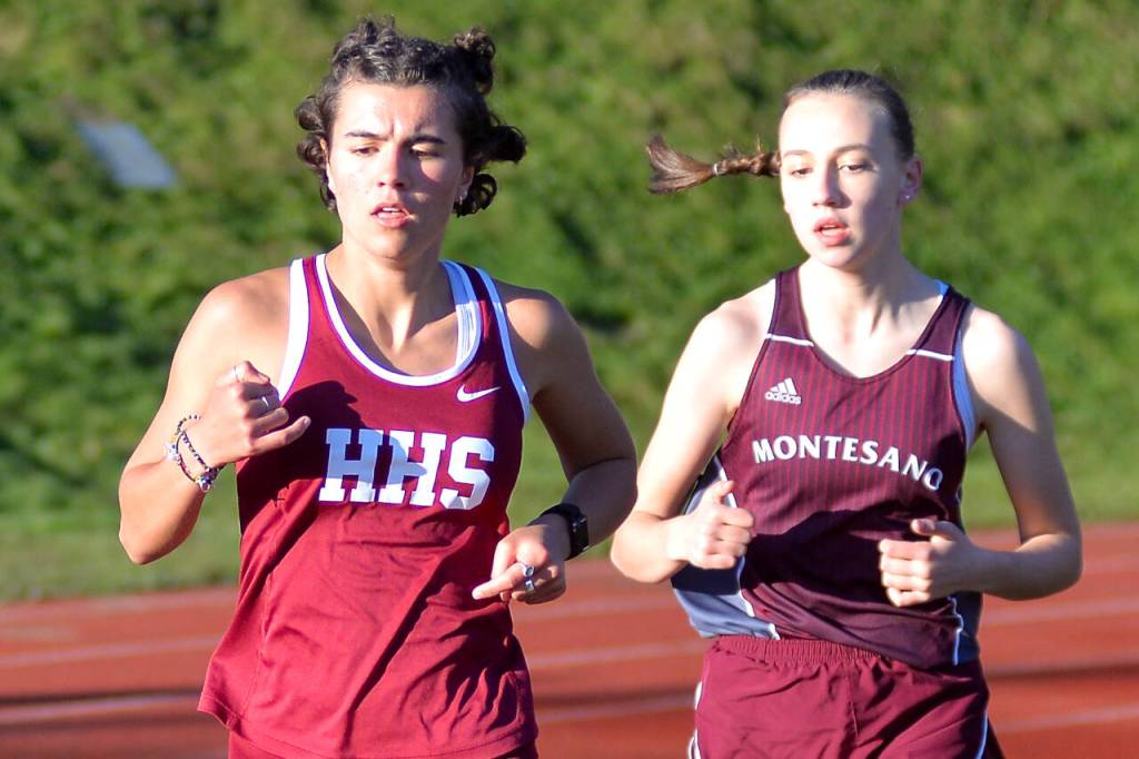RYAN SPARKS | THE DAILY WORLD Hoquiams Jane Roloff, left, leads Montesanos Samantha Schweppe in the girls 1600 meter race during the Ray Ryan Memorial Grays Harbor Championships on Friday in Montesano.