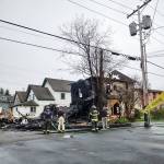 photo by Christopher Woodland 
Aberdeen Fire Department firefighters look at the damage to the two-story vacant residence that a fire destroyed on Saturday morning, April 23, at 215 N. H St., in Aberdeen.