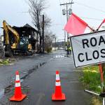 On Tuesday, April 26, an excavator sits outside the main part of the still-standing two-story residence at 215 N. H St., in Aberdeen, which went up in flames early Saturday morning, April 23. (Matthew N. Wells | The Daily World)