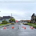 A Road Closed, sign is accompanied Tuesday morning, April 26, by several orange cones and yellow police tape, in order to block off North H Street at East 2nd Street. Arson is believed to have caused the third house on the right  215 N. H St.,  to be blackened and destroyed by fire and smoke three days after it caught fire early Saturday morning. (Matthew N. Wells | The Daily World)