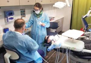 Allen Leister | The Daily World
A patient gets a chipped tooth repaired by the dentists inside the SmileMobile on April 26, 2022, in Elma.
