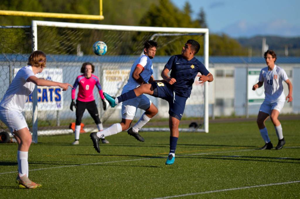 RYAN SPARKS | THE DAILY WORLD Aberdeens Daniel Guzman (23) and Ridgefields Sid Bryant jump for an inbound ball during a 2A District 4 playoff game on Tuesday at Stewart Field in Aberdeen.
