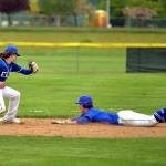 RYAN SPARKS | THE DAILY WORLD Elma infielder Jack Alexander, left, attempts to tag out La Center baserunner Smith Stimmel during the Eagles 3-0 loss in the 1A District 4 championship game on Friday at Castle Rock High School.