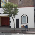 A shopping cart full of belongings outside of 111 W. Wishkah St. in Aberdeen on Tuesday, May 17, 2022. The building, owned by Terry Emmert, is one of many vacant buildings in the downtown corridor frequented by members of the homeless community. Erika Gebhardt | The Daily World