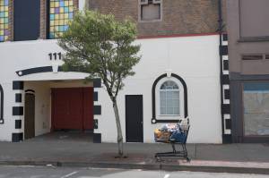 A shopping cart full of belongings outside of 111 W. Wishkah St. in Aberdeen on Tuesday, May 17, 2022. The building, owned by Terry Emmert, is one of many vacant buildings in the downtown corridor frequented by members of the homeless community. Erika Gebhardt | The Daily World