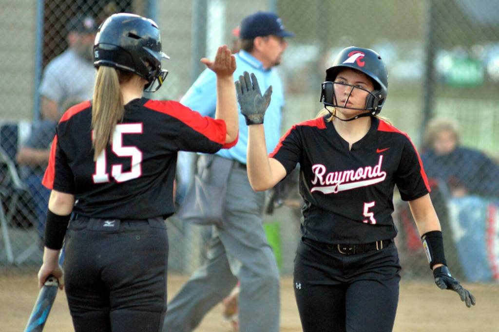 RYAN SPARKS | THE DAILY WORLD Raymonds Callie McVey (5) is congratulated by teammate Candence Swogger after scoring a run in the Seagulls 11-9 loss to Toledo in the 2B District 4 Tournament on Friday in Centralia.