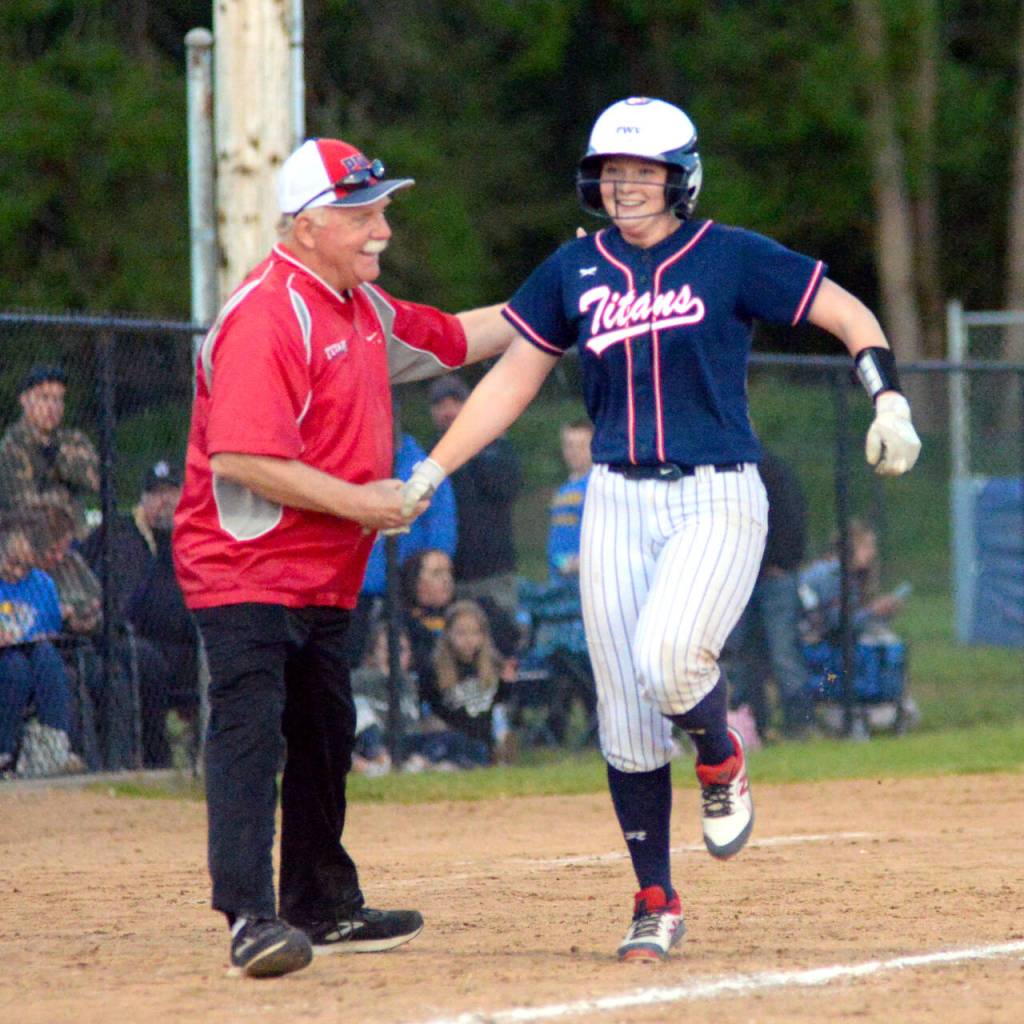 RYAN SPARKS | THE DAILY WORLD Pe Ell-Willapa Valleys Olivia Matlock shakes hands with head coach Ken Olson after hitting a home run in the seventh inning of the Titans 14-13 loss in the 2B District 4 Tournament championship game on Saturday at Fort Borst Park in Centralia.