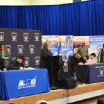 Allen Leister l The Daily World 
Students sign apprenticeship paperwork as their sponsoring company watches from behind during the AJAC Signing Ceremony at Elma High School on May 19, 2022, in Elma.
