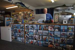 Eric McMurry, owner of Ocean Sportfishing Charters, stands behind a counter that features all local catches from past years in and around Westport. The Westport community is learning to integrate traditional industry into its tourism offerings to create unique and authentic experiences in Grays Harbor. Matthew N. Wells | The Daily World