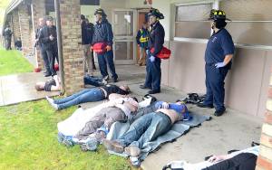 The Daily World | File Photos 
In an active shooter drill from April 28, 2018, victims are laid outside the 200 Building at Grays Harbor College. Deceased victims are placed with their arms crossed over their chests so medical personnel know to attend to other victims.