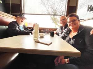 Matthew N. Wells | The Daily World 
On Wednesday, June 22, 2022, Shelly Dayton, owner of Simpson Avenue Grill and Lounge, sits with her two coffee guys, Louie Grant, left, and Al Dick. Grant said he goes to Simpson Avenue Grill every day of the week, and hell miss the place when it closes on Sunday, June 26. The two customers are emblematic of what Dayton will miss most, the customers shes had that are like family to her.