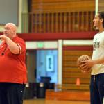 RYAN SPARKS | THE DAILY WORLD Hoquiam girls basketball head coach Chad Allan, left, and NBA player CJ Elleby talk to participants at the Hoquiam Youth Basketball Camp on Thursday at Hoquiam High School.