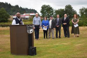 Willie Nunn, director of the Federal Emergency Management Agencys Region 10, which serves Washington State, Alaska, Oregon, and Idaho, speaks about the significance in the city of Aberdeen receiving $50 million in Building Resilient Infrastructure and Communities grant funding for the North Shore Levee Project, as local and state officials stand behind him. (Matthew N. Wells | The Daily World)