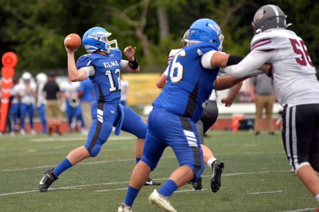 DAILY WORLD FILE PHOTO 
Elma quarterback Carter Studer, left, throws a pass during the Montesano Football Jamboree on Friday, Aug. 26, 2022, in Montesano.