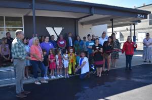 Allen Leister | The Daily World
YMCA of Grays Harbor Enrichment Director Dannielle Oliver (holding scissors) cuts the ceremonial ribbon of the newly licensed YMCA Learning Center on Tuesday, Sept. 6, 2022, in Hoquiam. Oliver and YMCA of Grays Harbor CEO Franzine Potts (right of Oliver) led the drive for the creation of the more than $2.05 million facility.