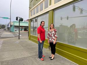 Matthew N. Wells | The Daily World
Lee and Dani Bacon stand outside their building at the intersection of West Wishkah and South K streets in Aberdeen. The 92-year-old urban moss green building used to house Goldbergs Furniture. The couple, who spoke to <em>The Daily World</em> on Friday, Sept. 2, 2022, bought the building in April 2021. They have been working to restore and revitalize it since May 2021.